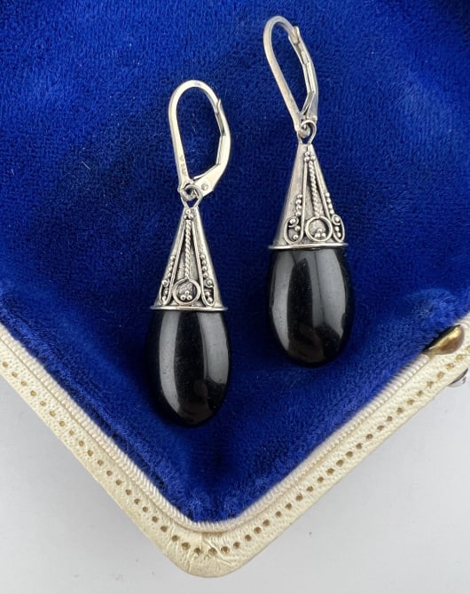 Sterling Silver Etruscan Revival Style Earrings: Pair of Sterling Silver Etruscan Revival Style Earrings. Hallmarked. Each with granulation / cannetille style work on the tops. Each with latch back ear wires. Each measures 1.75 of an inch in length.