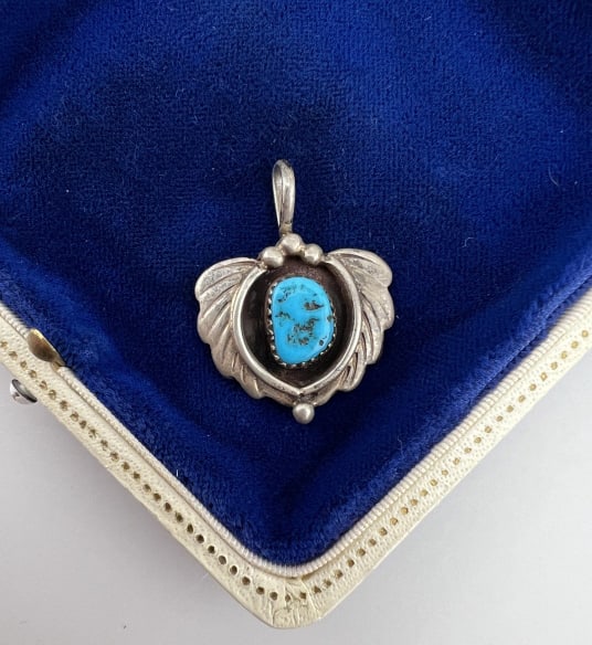 Vintage Native American Sterling Turquoise Pendant: Vintage Native American Sterling Turquoise Pendant. Necklace pendant, sterling silver, set with turquoise. Back is signed with name and stamped STERLING. Measures 1.25 inches in length.