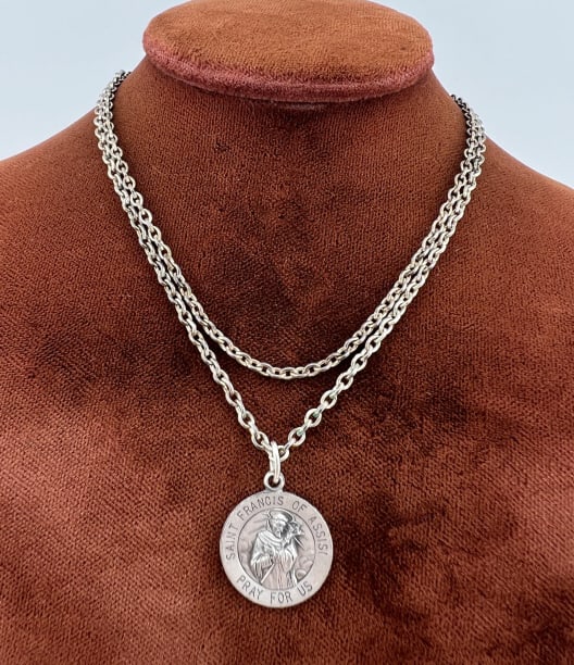 Sterling Saint Francis of Assisi Religious Medal: Sterling Saint Francis of Assisi Religious Medal on Chain. Medal is hallmarked on the back. Chain measures 20 inches in length.