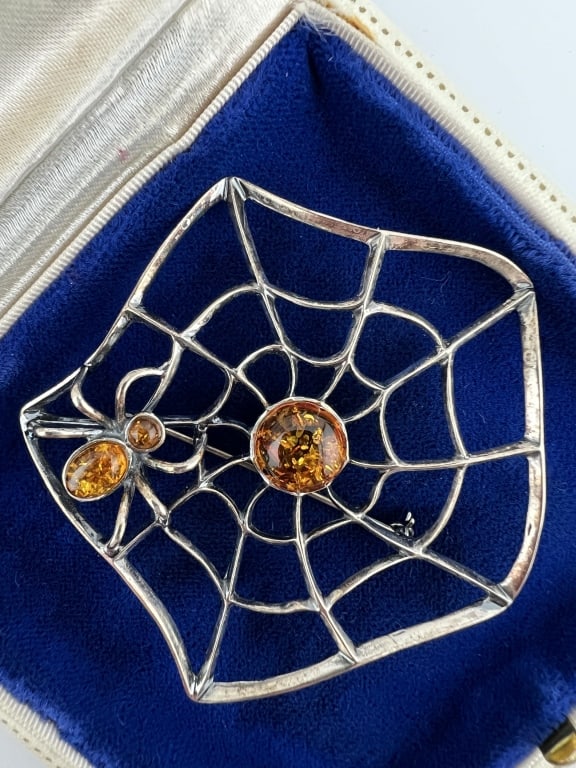 Large Figural Sterling & Amber Spider Pendant: Large Figural Sterling & Amber Spider Pendant. Sterling silver and amber spider in spider web necklace pendant or brooch. Hallmarked. Measures 2.5 inches in diameter.