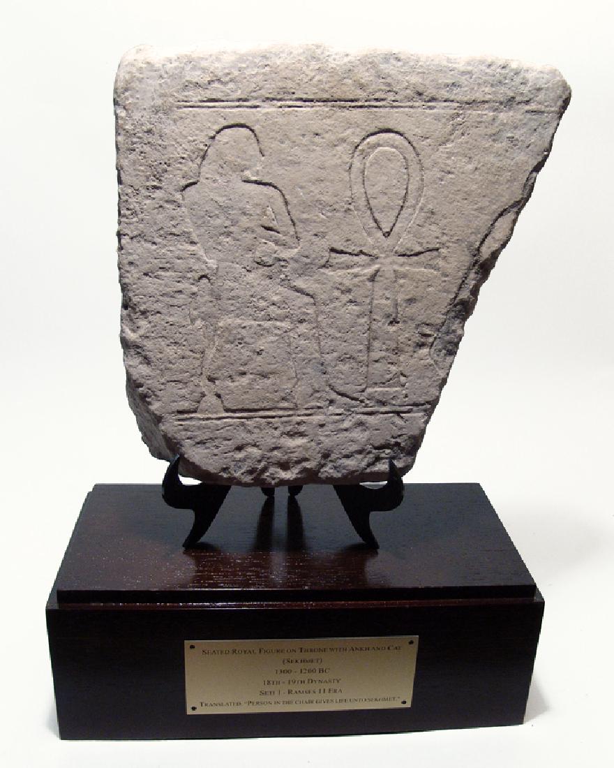 Egyptian limestone relief depicting seated royal figure (1 of 4)