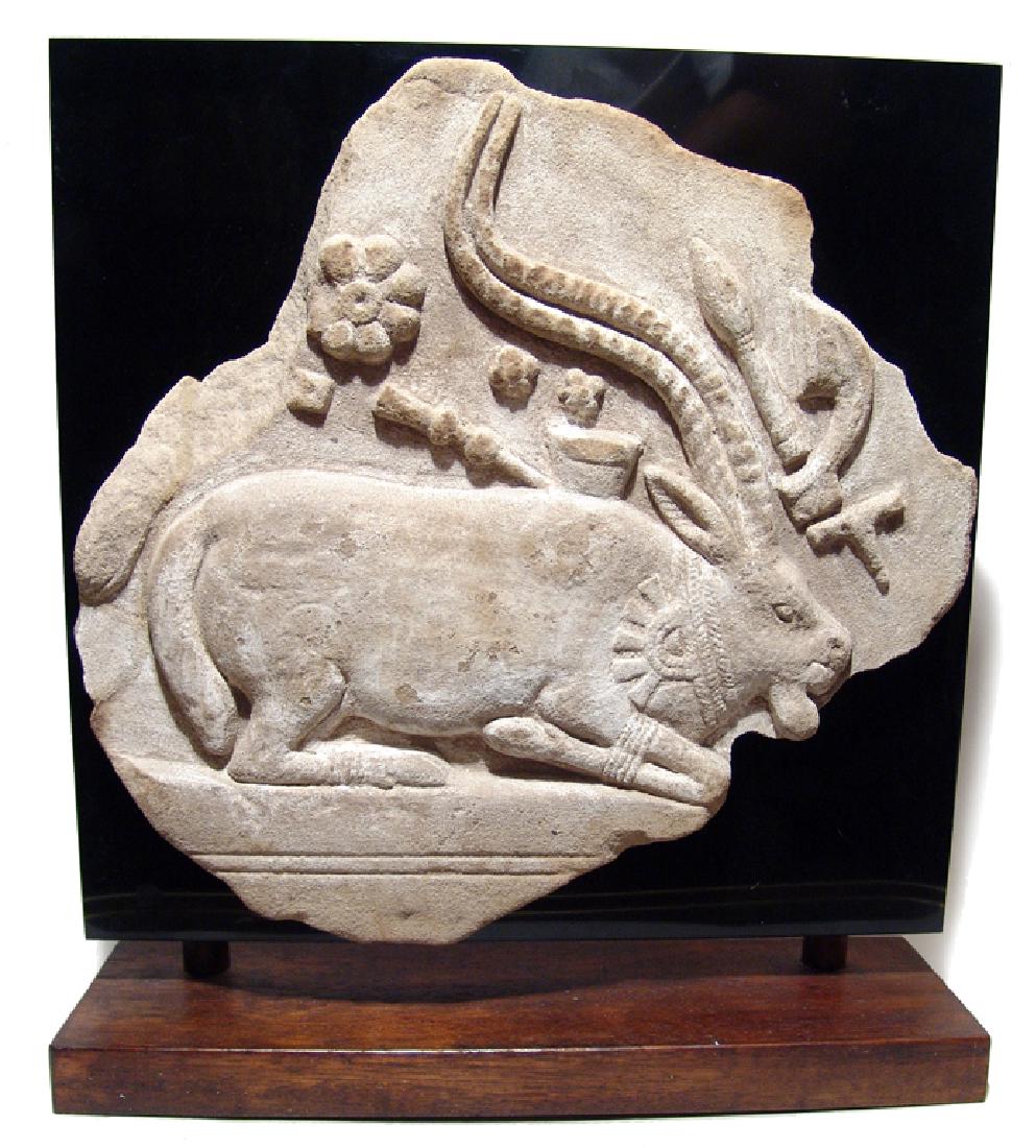 A choice Indus Valley sandstone relief of kneeling ibex (1 of 2)
