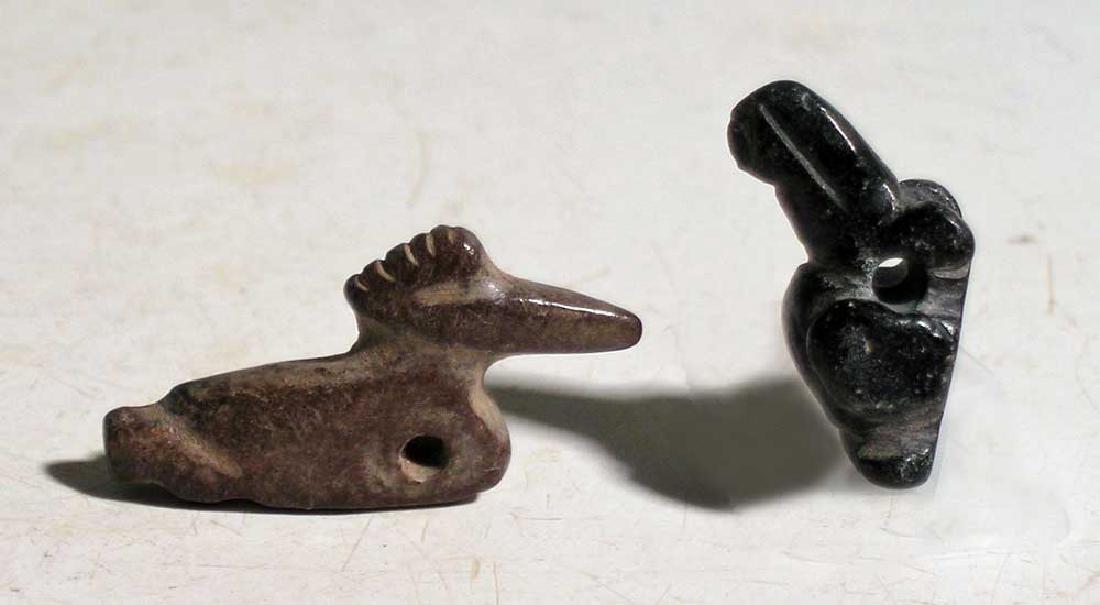 Pair of Tairona avian pendants from Colombia: A pair of Tairona avian pendants from Colombia, ca. AD 1000 - 1500. The first is a 1-1/8 in long sea bird with long beak, the second a 3/4 in long, nicely detailed parrot. Both are carved from jasper,