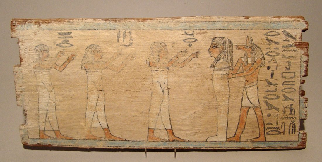 A beautiful Egyptian painted wood panel, Late Period: A beautiful Egyptian painted wood panel, Late Period, c. 664 – 332 BC, depicted the Jackal-headed god Anubis standing behind the deceased, three woman wearing tight-fitting gowns and long wigs prese