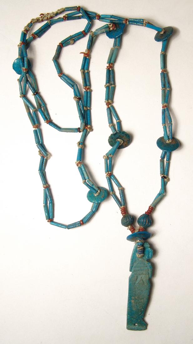 Lovely Egyptian turquoise beaded necklace, Imsety: Lovely Egyptian turquoise beaded necklace of tube, disc, and melon beads, and with a faience amulet of Imsety, Late Period, c. 664 - 30 BC, which was one of the four Sons of Horus. The beads are of va