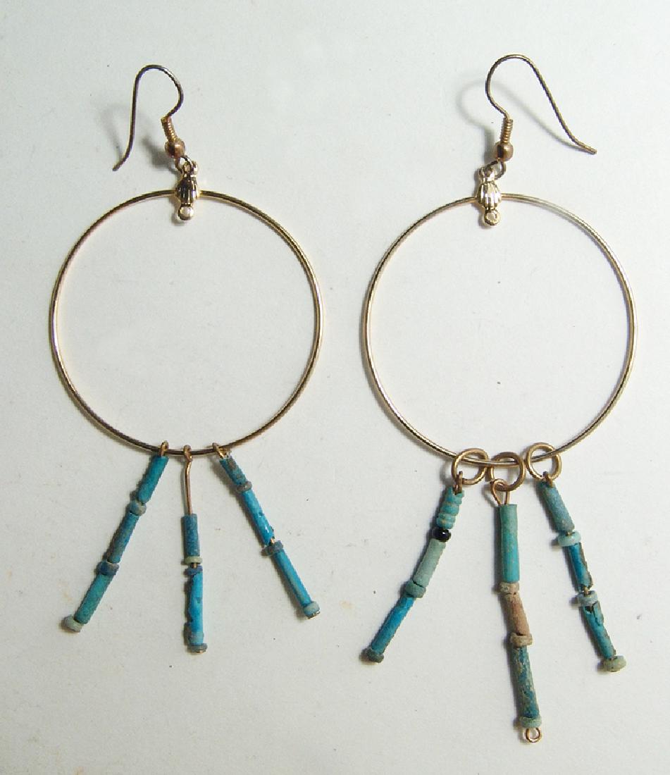 A pair of Egyptian faience bead earrings: A pair of Egyptian faience bead earrings. The multicolor faience beads date from the Late Period, c. 664 – 30 BC, and they have strung onto earrings in precise ancient style with brass fittings and 