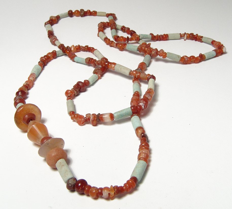 A nice Sasanian carnelian beaded necklace: A nice Sasanian carnelian beaded necklace, c. 3rd – 7th Century AD, the vibrant orange beads are of varying shapes but mostly uniform in size and strung with tubular composition beads from an earlie