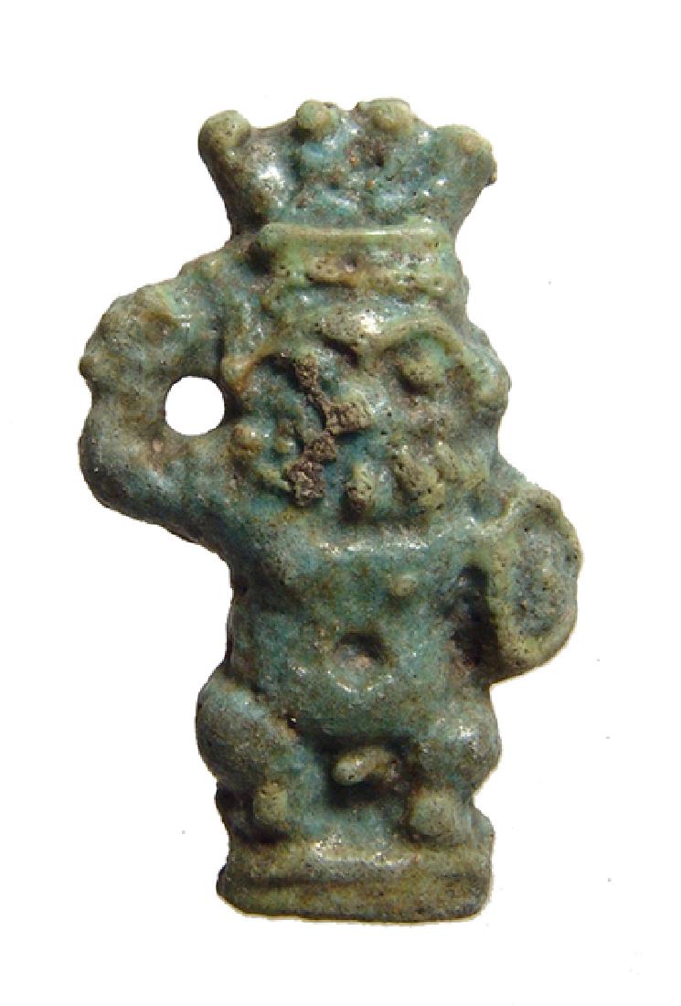 Egyptian green glazed faience amulet of Bes, Ptolemaic: A nice Egyptian green glazed faience amulet of Bes, Ptolemaic Period, c. 332 – 30 BC, depicted nude, wearing a plumed headdress, and holding a shield and an upraised sword. A neat type depicted Bes 