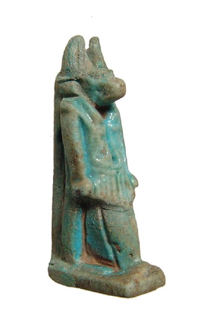 A fantastic turquoise glazed Egyptian Anubis amulet: A well-preserved turquoise glazed Egyptian amulet of Anubis, Late Period, c. 664 - 30 BC, with excellent detail and with suspension loop through plinth at shoulders. H: 1 4/5 in (4.6cm). Ex Southern C