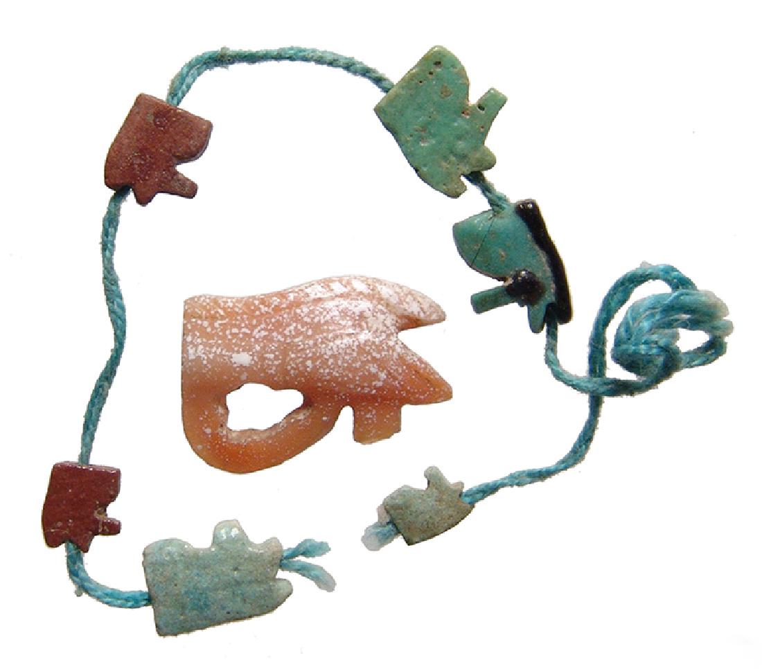 A lot of 7 Egyptian Eye of Horus amulets: A lot of 7 Egyptian Eye of Horus amulets. Lot includes a nice carnelian example, 3rd Intermediate Period, c. 1075 - 664 BC, with nice color and incised detail which is extremely hard to catch in the i
