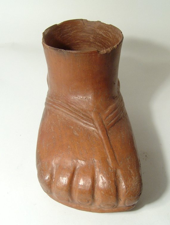 A fantastic Pre-Columbian foot formed vessel: A fantastic Pre-Columbian foot formed vessel, c. AD 200 Â– 600, nearly life-size jar in the form of a sandaled human foot with thick brown slip, the toes clearly delineated with distinct toenails, 