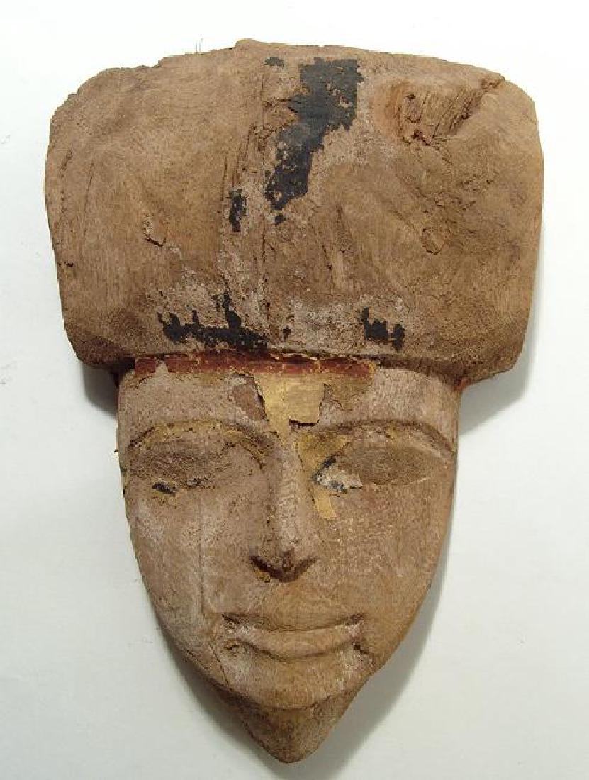 A lovely Egyptian wooden mummy mask, Late Period: A lovely Egyptian wooden mummy mask, Late Period, c. 664 - 332 BC, with large headdress and remnants of original painted gesso. The face is nicely detailed with large eyes and naturalistic lips. H: 10
