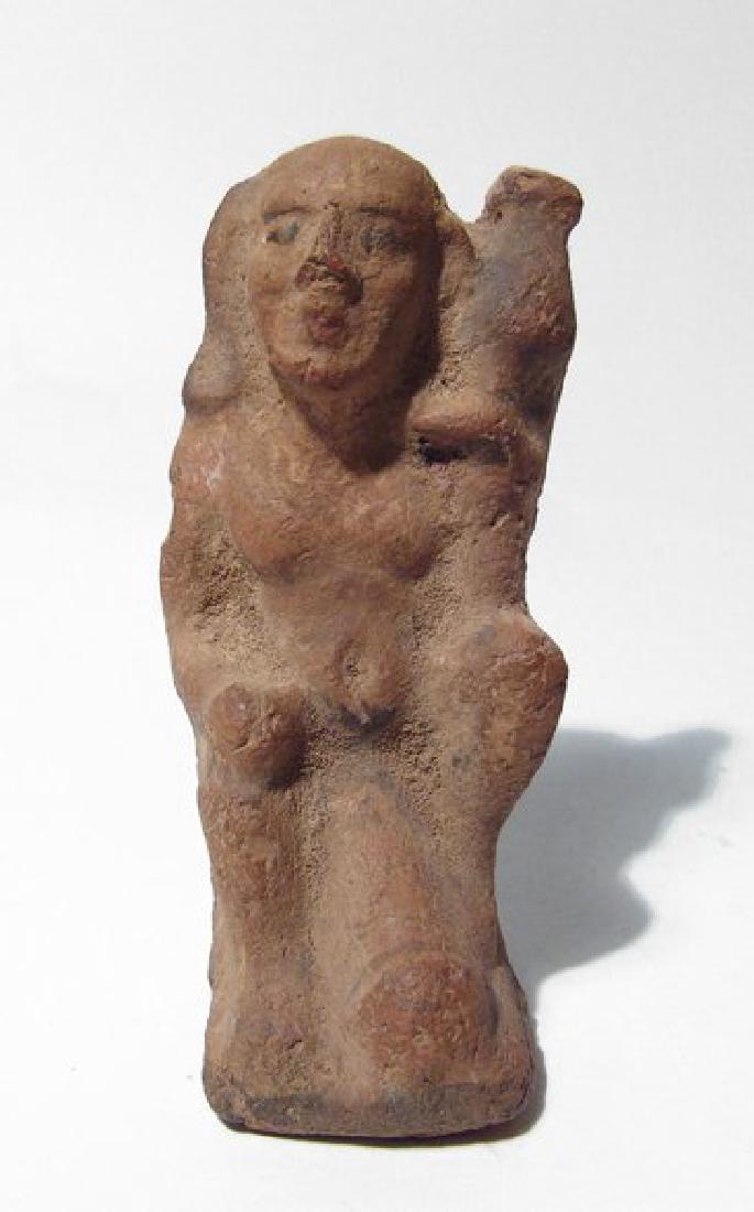 Egyptian ceramic figure of ithyphallic: An Egyptian ceramic figure of ithyphallic Horus, Graeco-Roman, c. 3rd - 1st Century BC, depicted seated with large engorged penis and holding a water jar with left hand, uncertain object in right hand
