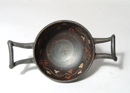 A Greek black-ware kylix, Magnia Graecia: A Greek black-ware kylix, Magnia Graecia, c. 4th Century BC, with a lovely metallic sheen, D: 3 4/5 in (9.6cm), H: 2 1/8 in (5.5cm). The silver-grey glaze is offset by excellent detailing of the