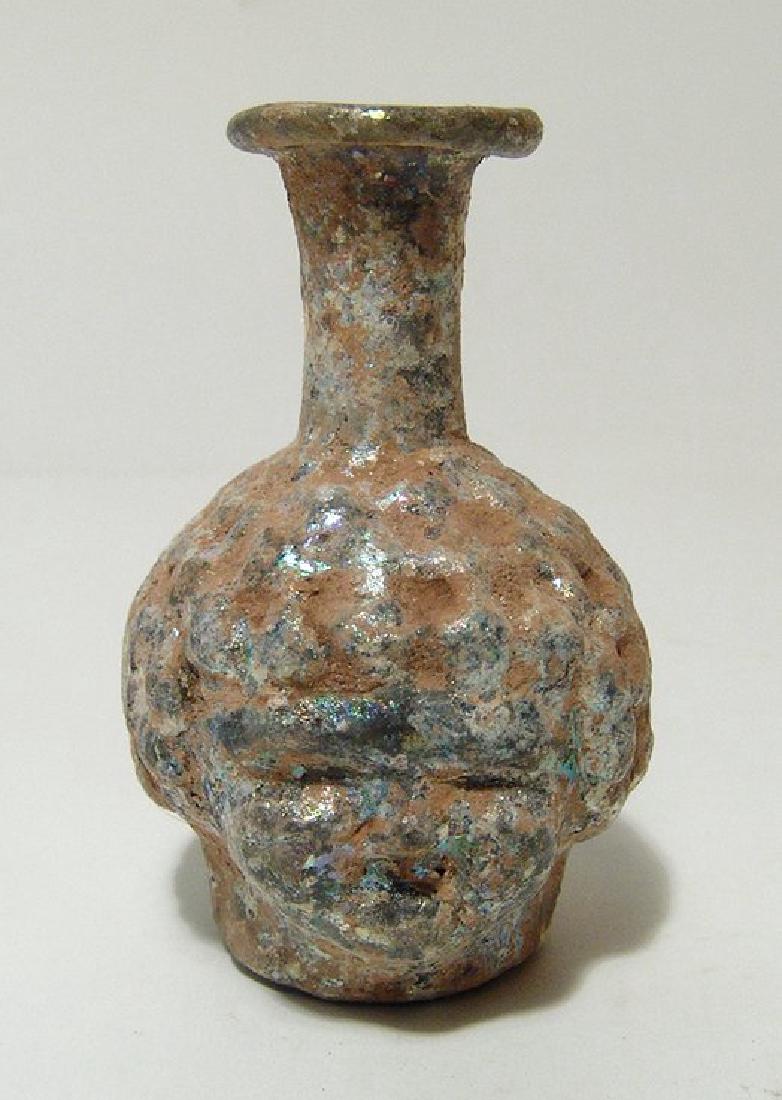 A Roman glass mold-blown janiform head flask (1 of 4)