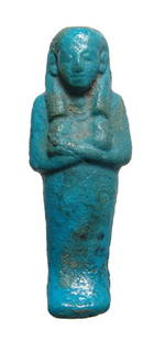 A nice Egyptian turquoise glazed faience ushabti: A nice Egyptian turquoise glazed faience ushabti, 3rd Intermediate Period, c. 1075 - 945 BC, depicted mummiform wearing tripartite wig, arms crossed over chest, hands each holding a hoe, basket on