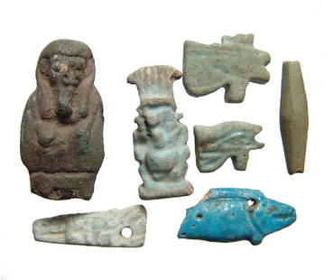 A group of 7 Egyptian faience amulets and fragments: A group of 7 Egyptian faience amulets and fragments, Late Period, c. 664 - 30 BC, and include an amulet of Bes, a crocodile representing Sobek, two Eye of Horus amulets, a nice blue amulet of a fish,