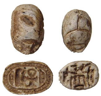 A pair of Egyptian steatite scarabs: A pair of Egyptian steatite scarabs. Lot includes a 3rd Intermediate example, c. 1075 - 664 BC, carved from steatite, the base with a feather, Nefer and Ankh flanked by neb signs; all within a rope