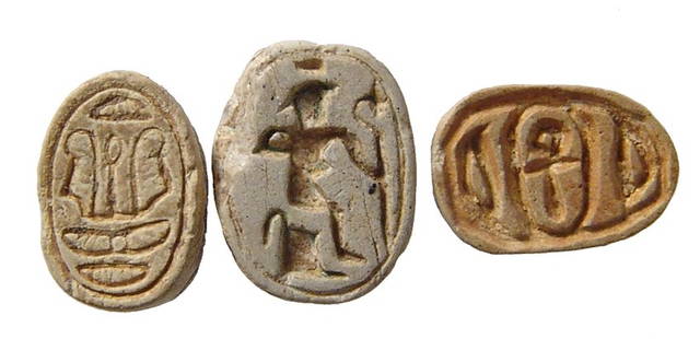 A trio of small Egyptian steatite scarabs: A trio of small Egyptian steatite scarabs. Lot includes a New Kingdom example, c. 1570 - 1075 BC, depicting Harpokrates seated holding a scepter, (11 x 8 mm), and a pair of 2nd Intermediate types, c.