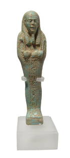 Egyptian pale blue-green faience ushabti, Late Period: An Egyptian pale blue-green faience ushabti, Late Period, c. 664 - 332 BC, on integral base, mummiform wearing tripartite wig and false beard, arms folded at chest, hands holding a pick and hoe, baske