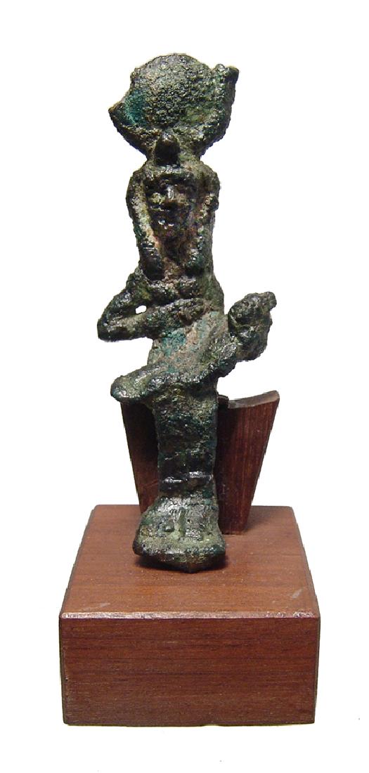Egyptian bronze figurine of Isis and the child Horus: An Egyptian bronze figurine of Isis and the child Horus, Late Period, c. 664 - 332 BC, the goddess is depicted seated wearing a headdress consisting of a solar disk with horns and uraeus, she wears a 