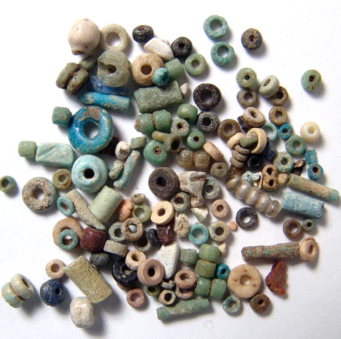 Group of 100 Egyptian multi-colored faience beads: A group of 100 Egyptian multi-colored faience beads, Late Period, c. 664 - 343 BC, consists of beautiful tube and disk beads in a good state of preservation with good color. Ex Los Angeles private col