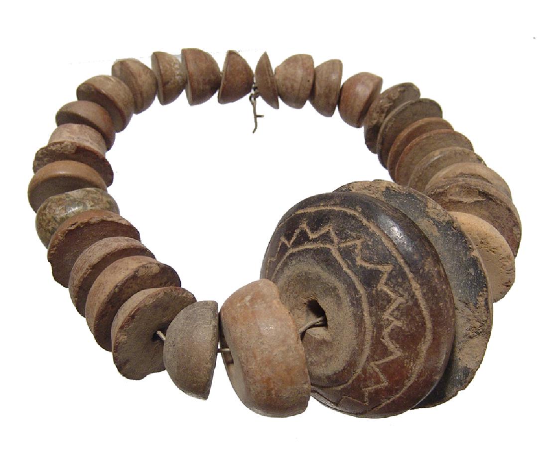 A strand of 29 Mayan ceramic spindle whorls (1 of 4)