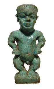 Fantastic Egyptian green glazed faience Pataikos amulet: A large Egyptian green glazed faience amulet of Pataikos, Late Period, c. 664 – 30 BC, depicted nude and standing on integral base in the characteristic guise of a nude dwarf, wearing close-fitting