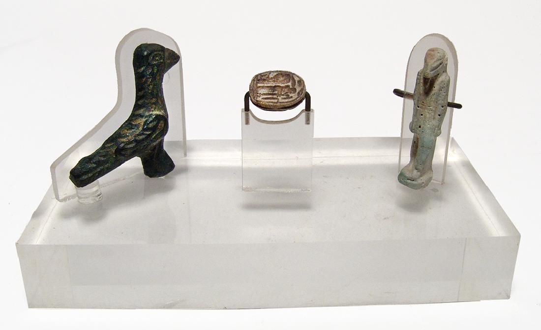 A nicely mounted trio of ancient objects: A nicely mounted trio of ancient objects. Lot includes an Egyptian steatite scarab, Late Period, c. 664 - 332 BC, with nicely carved body and a cobra and the god Ptah on base, 18 x 14 mm. The second i
