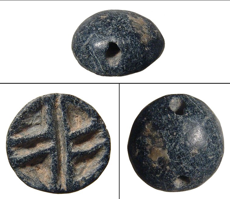A nice Uruk/Jemdat Nasr black chlorite stamp seal: A nice Uruk/Jemdat Nasr black chlorite stamp seal, c. 3300 – 3000 BC, ovoid with longitudal drill for suspension, on back a central bull’s head with goats on either side; various symbols as fill.