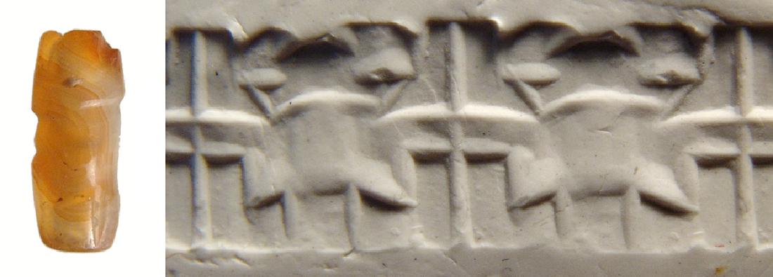 A small Levantine carnelian cylinder seal: A small Levantine carnelian cylinder seal, 2nd Millennium BC, with stylized scene depicting perhaps an altar. L: 13.5 mm. Nice translucent orange stone. Ex Northern California private collection.