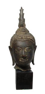 A choice Lana bronze Buddha head from Thailand: A choice Lana bronze Buddha head from Thailand, 19th Century, with eyes lowered in meditation and serene demeanor. H: 7 1/4 in (18.5 cm). Beautifully patinated and quite attractive. Removable black