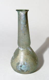 A pleasing Roman pale green glass bottle: A pleasing Roman pale green glass bottle, 2nd - 3rd Century AD, the piriform body with slightly indented base, tall tubular neck with slight constriction at base and flattened mouth with inward