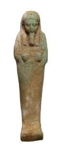 An Egyptian light green faience ushabti: An Egyptian light green faience ushabti, c. 664 - 332 BC, depicted mummiform wearing tripartite wig and false beard, arms folded at chest with a hoe in each hand, basket over left shoulder and