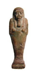 An Egyptian deep green faience ushabti, Late Period: An Egyptian deep green faience ushabti, Late Period, c. 664 - 30 BC, on integral base, depicted mummiform, wearing tripartite wig and false beard, arms folded at chest and holding a pick and hoe;