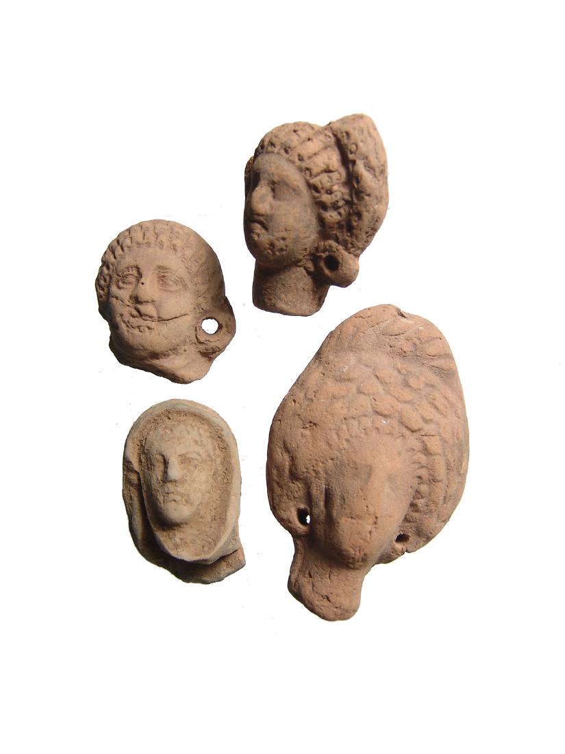 A lot of 4 Romano-Egyptian terracotta heads: A lot of 4 Romano-Egyptian terracotta heads, c. 2nd Century BC/AD, including two women with elaborate hair styles, a youth with short curly hair and a veiled priest. Each nicely preserved Largest 3 in