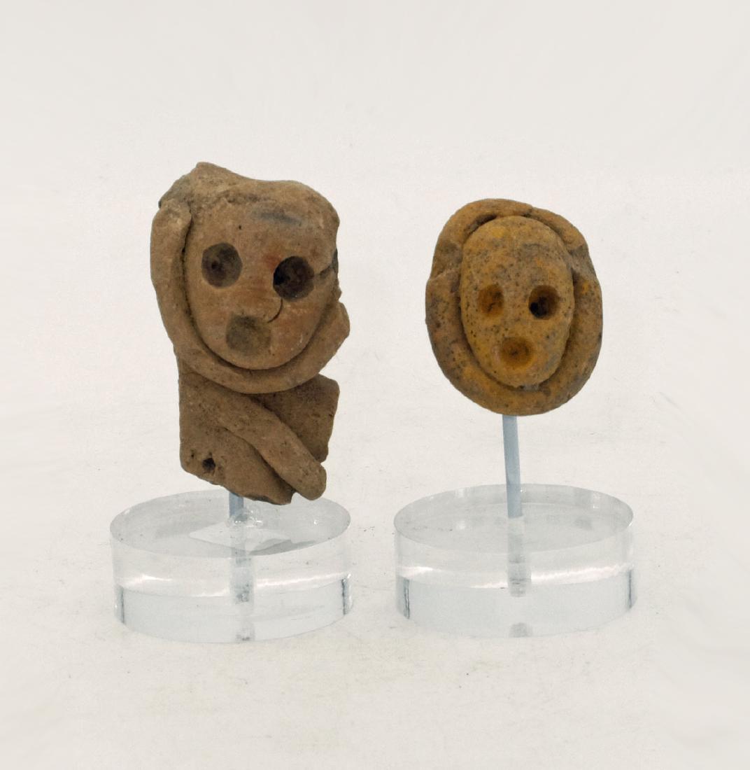 A matched pair of heads from Teotihuacan, Mexico: A matched pair of heads from Teotihuacan, Mexico, c. AD 400 - 650. They are 1 3/4 in and 1 1/4 in high and depict Xipe Totec priests wearing the flayed skin masks of their sacrificial victims. One ret