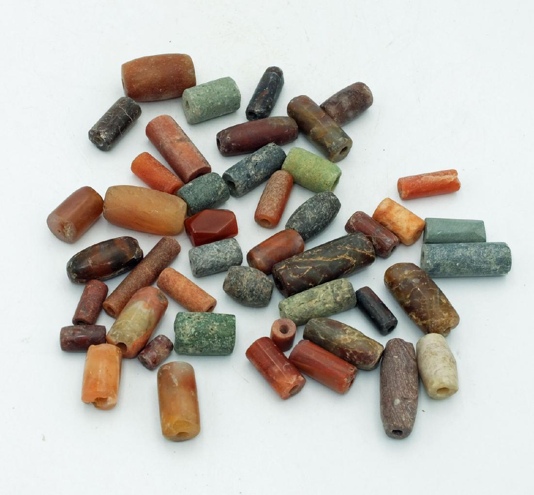 A collection of 45 Tairona beads from Colombia: A collection of 45 Tairona beads from Colombia, c. AD 1000 - 1500. The group consists of tube beads ranging from 5/8 in to 1 1/4 in in length, made from highly polished carnelian and chrysocolla stone
