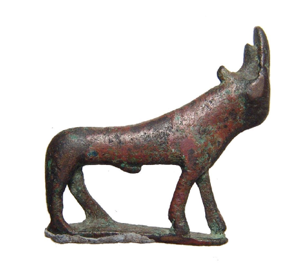 An Egyptian bronze Apis bull figurine: An Egyptian bronze Apis bull figurine, Late Period, c. 664 - 332 BC, on integral base with attractive patination. Dimensions: 1 1/2 x 1 5/8 in (3.8 x 4.2 cm). Ex collection of J.D.R Fryer, UK.
