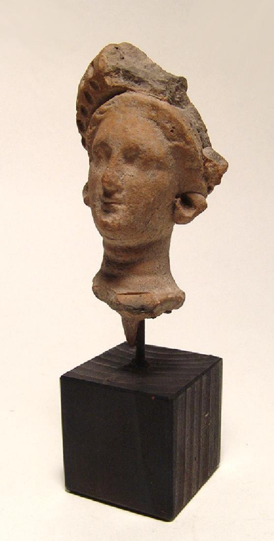 A nice Hellenistic Greek terracotta head of a female (1 of 5)