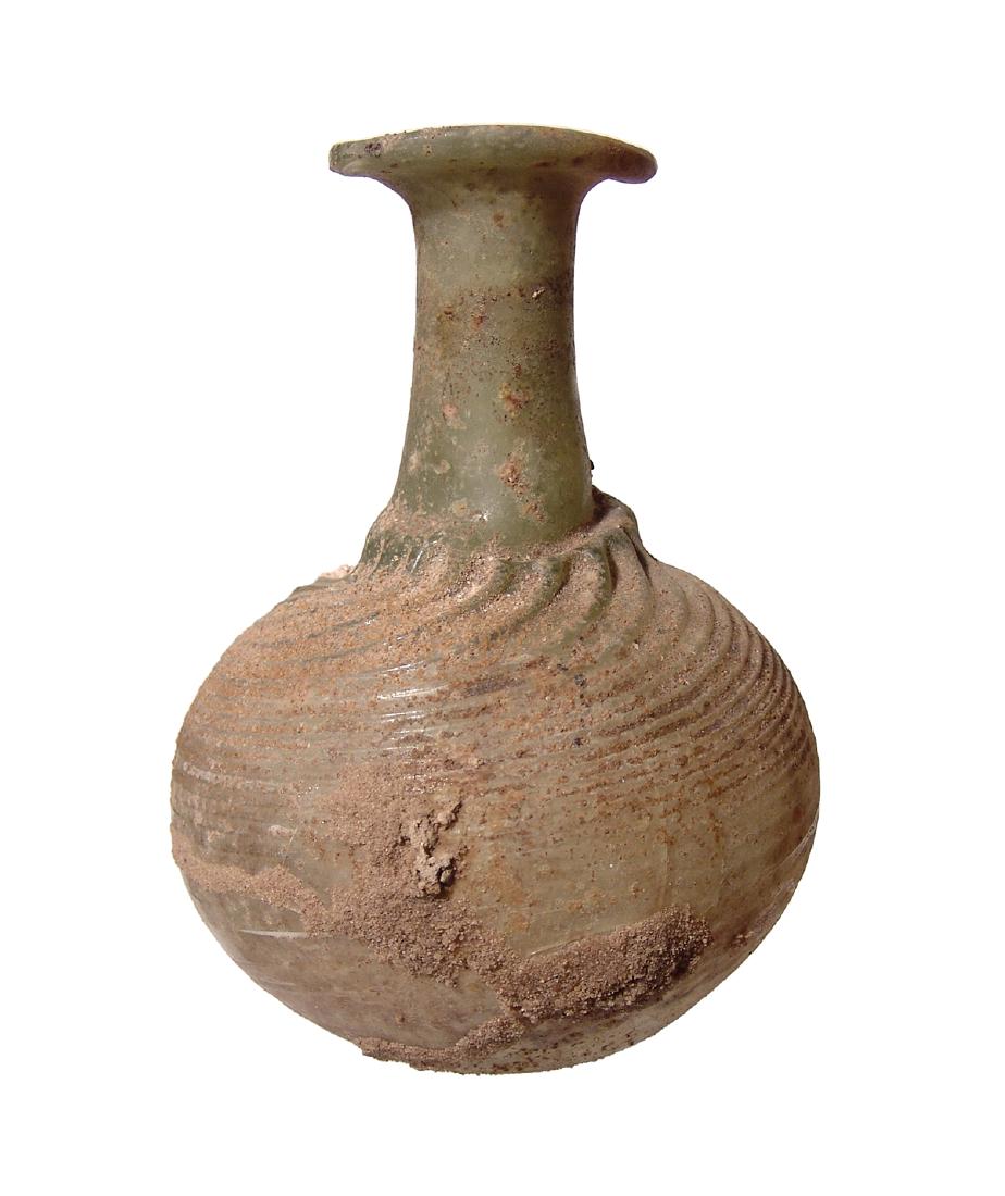 A large Roman yellow-green glass bottle (1 of 3)