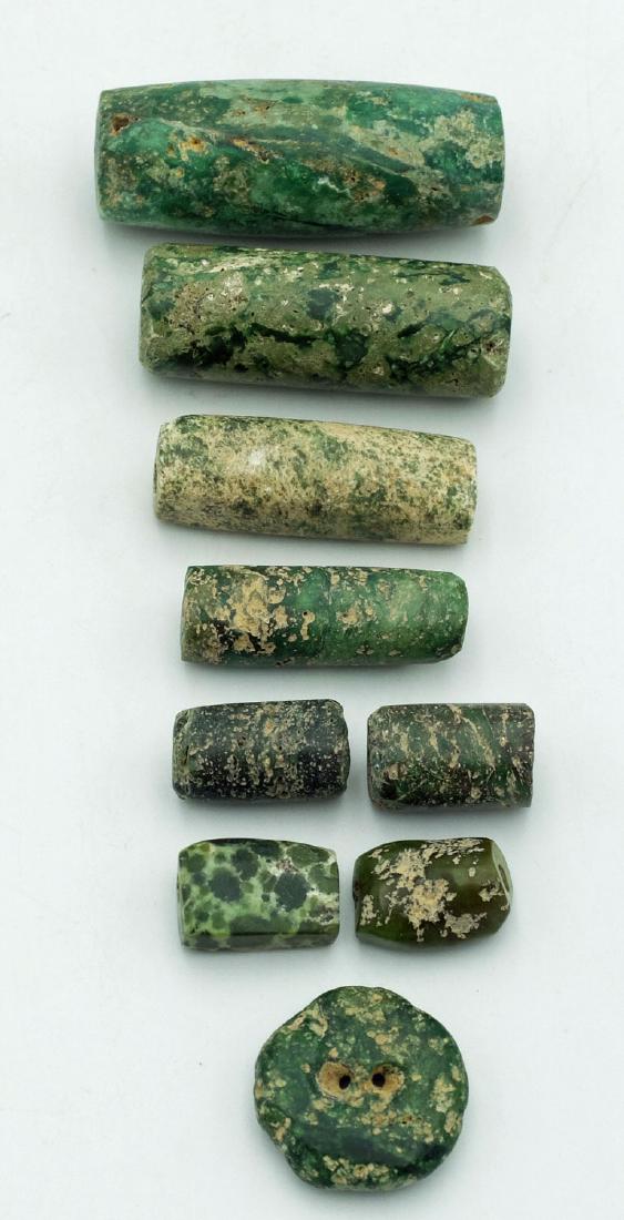 Nine colorful Tairona chrysocolla beads from Colombia: A group of nine colorful Tairona chrysocolla beads from Colombia, c. AD 1000 - 1500. These beautiful speckled greenstone beads range from 1/2 in to 1 5/8 in in length and are biconically drilled for s