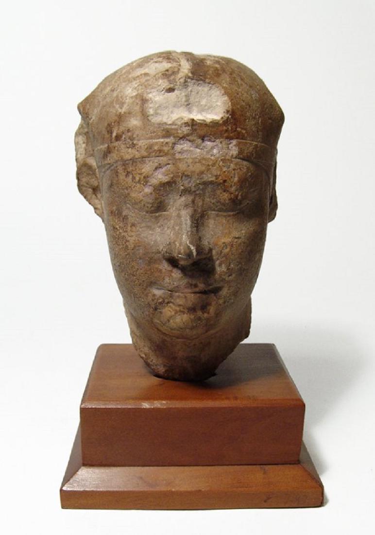 Egyptian limestone pharaoh head wearing headdress (1 of 4)