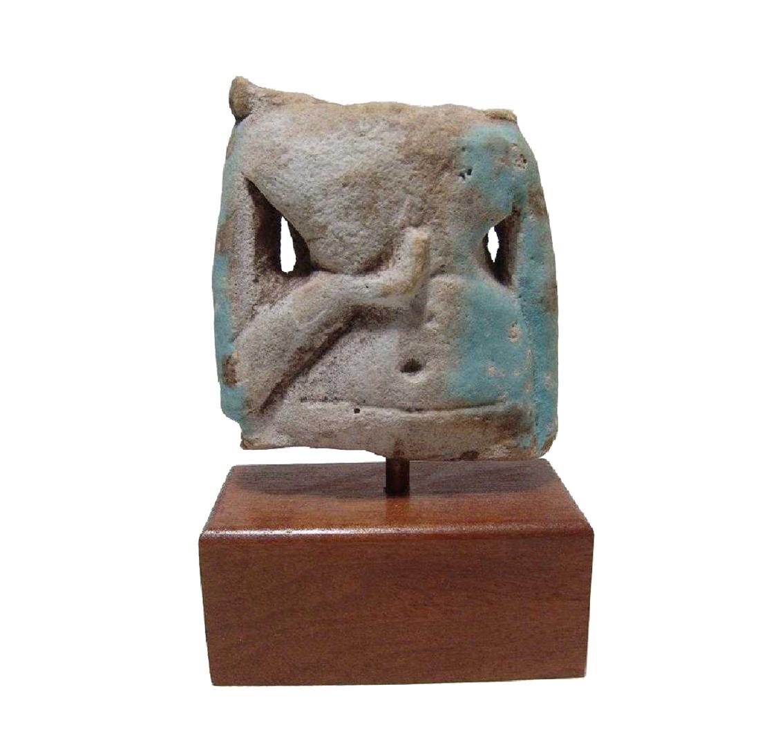 An Egyptian faience torso from a concubine figure: An Egyptian faience torso from a concubine figure, Late Period, c. 664 - 32 BC, with wonderful detail. The right hand cupped beneath her right breast, left arm pendant at side. Light blue glaze remain