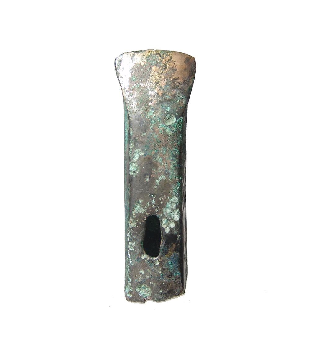 A nice Chinese bronze socketed adze, Shang-Zhou: A nice Chinese bronze socketed adze, Shang-Zhou, c. 1100 - 800 BC, with flattened sides, a slightly flared, rounded cutting edge and a slit for fastening to a handle that had a right-angle curve. L: 2