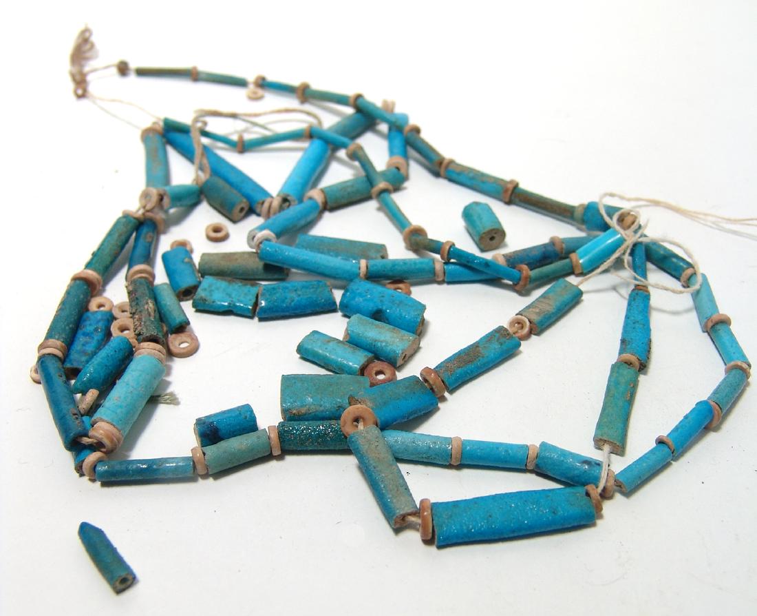 A group of Egyptian faience beads: A group of Egyptian faience beads, 3rd Intermediate - Late Period, c. 1075 - 332 BC, including a strand intermixed with loose beads. The group is primarily comprised of thick deep blue tubular beads, 
