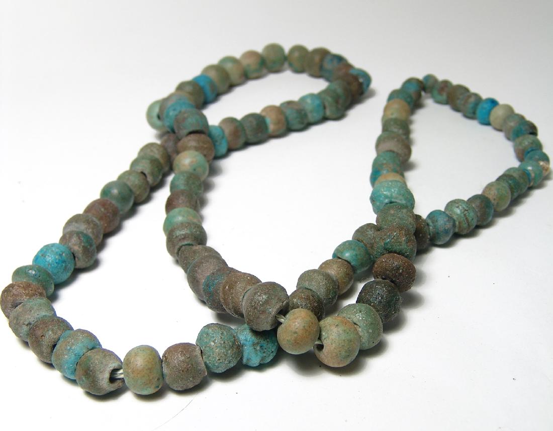 A huge strand of Egyptian round faience beads: A huge strand of Egyptian round faience beads, Graeco-Roman, c. 2nd Century BC - 2nd Century AD, all very similar in size with well-preserved glaze in shades of green and blue. Length about 38 in (96.