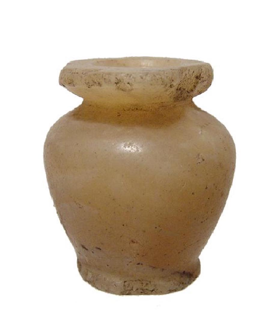 An Egyptian alabaster kohl jar, Middle Kingdom: An Egyptian alabaster kohl jar, Middle Kingdom, c. 2061 - 1690 BC, the body piriform with lightly flared foot, short neck and wide, flat rim; the interior well-bored with thick walls. H: 1 1/2 in (3.8