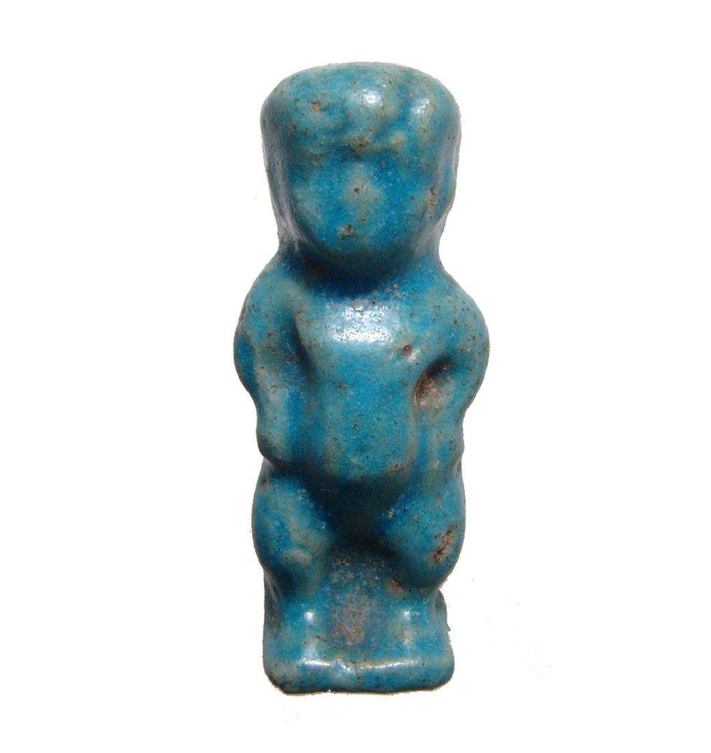 An Egyptian turquoise glazed amulet of Pataikos: An Egyptian turquoise glazed amulet of Pataikos, Late Period, c. 664 - 30 BC, with well-preserved glaze, suspension loop at back of neck. H: 2 1/5 in (5.6cm). Ex Somerset, UK private collection.
