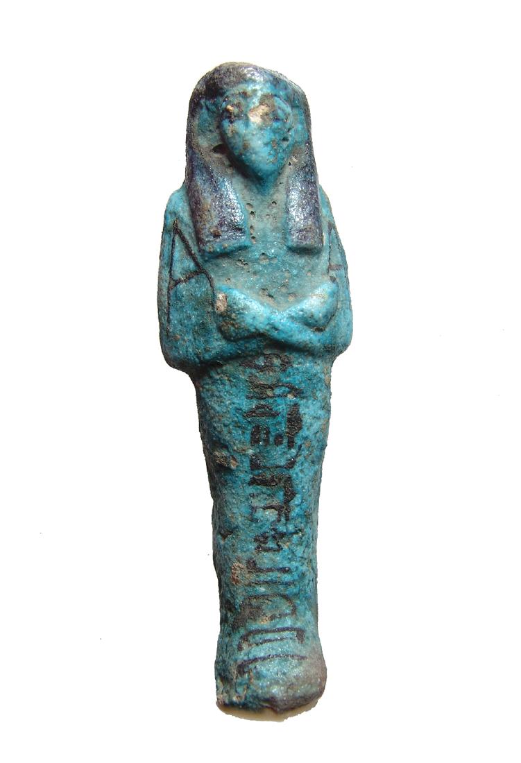 Egyptian bicolor faience ushabti, 3rd Intermediate: An Egyptian bicolor faience ushabti, 3rd Intermediate Period, 21st Dynasty, c. 1075 - 945 BC, mummiform, wearing tripartite wig, arms folded at chest, hands holding hoes, bag at center of back and ver